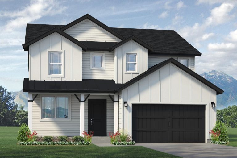 A modern two-story house with light-colored siding, black roof, and a double garage. Like many homes in Utah, it features small shrubs and flowers in front, set against mountains and a blue sky backdrop.
