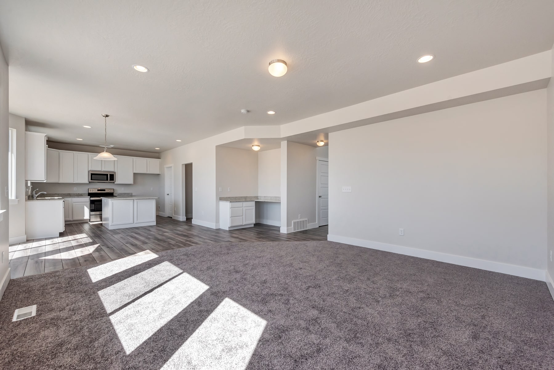 Open kitchen area and gathering area in a new home from McArthur Homes..