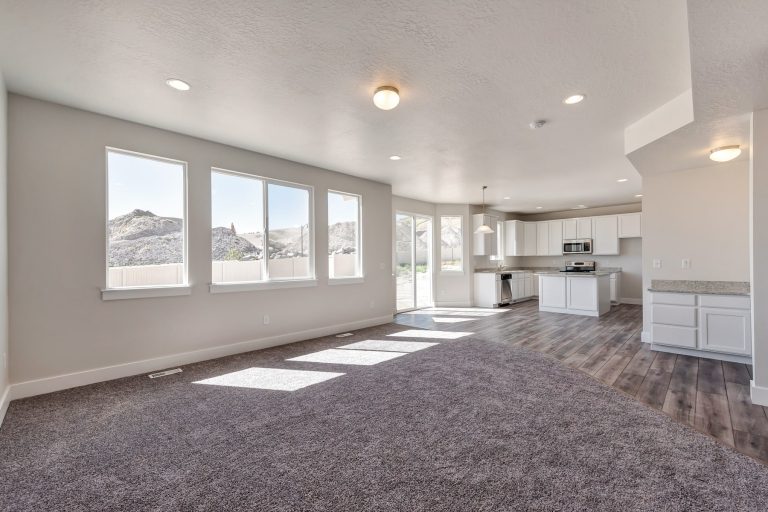 Open kitchen area and gathering area in a new home from McArthur Homes..