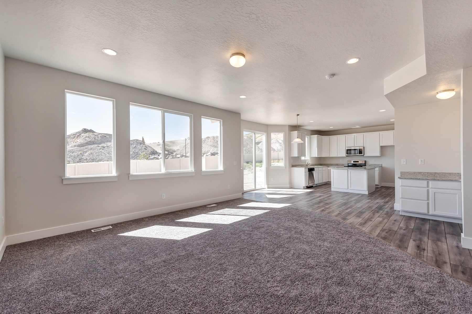 Open kitchen area and gathering area in a new home from McArthur Homes..