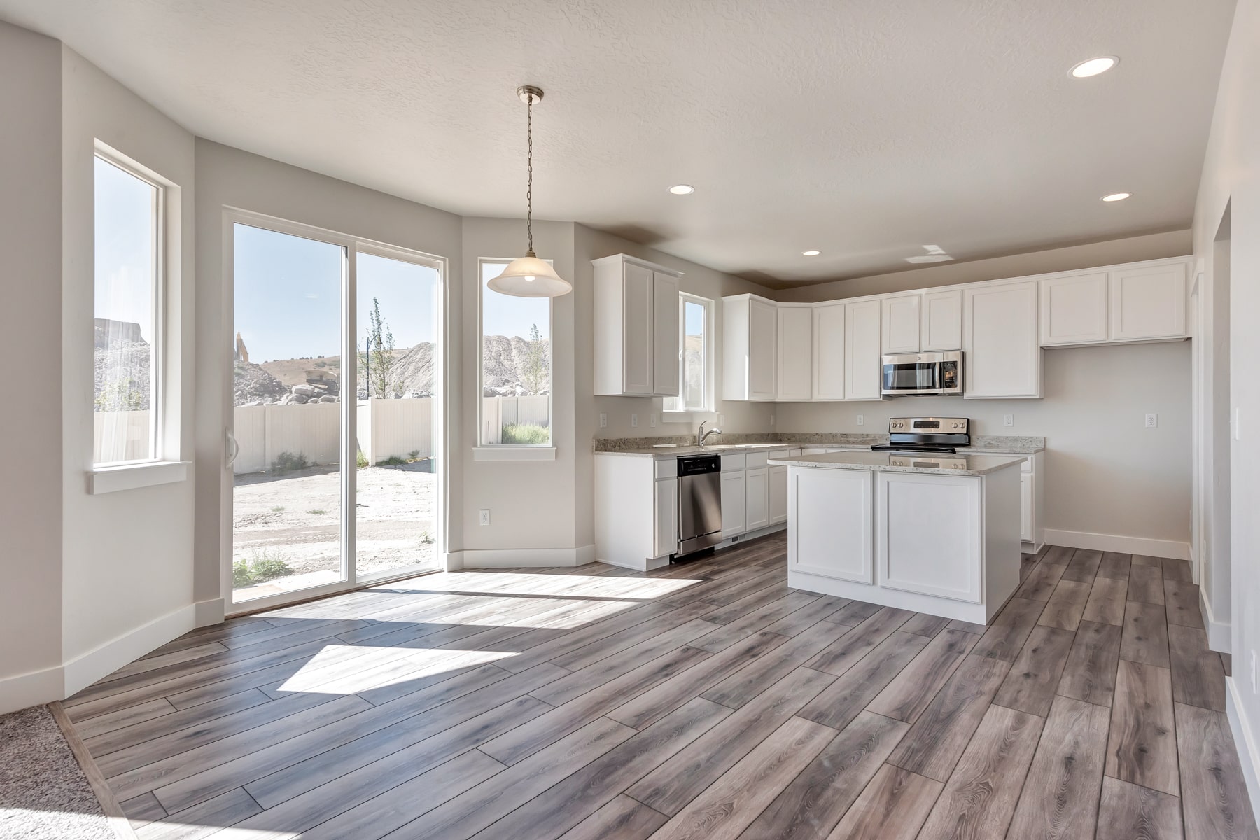 Kitchen with an island in a new home from McArthur Homes.