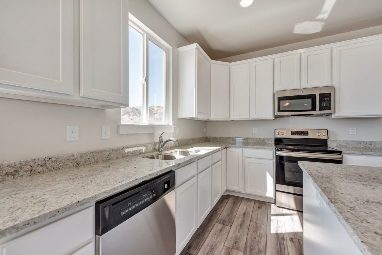 Kitchen with an island in a new home from McArthur Homes.