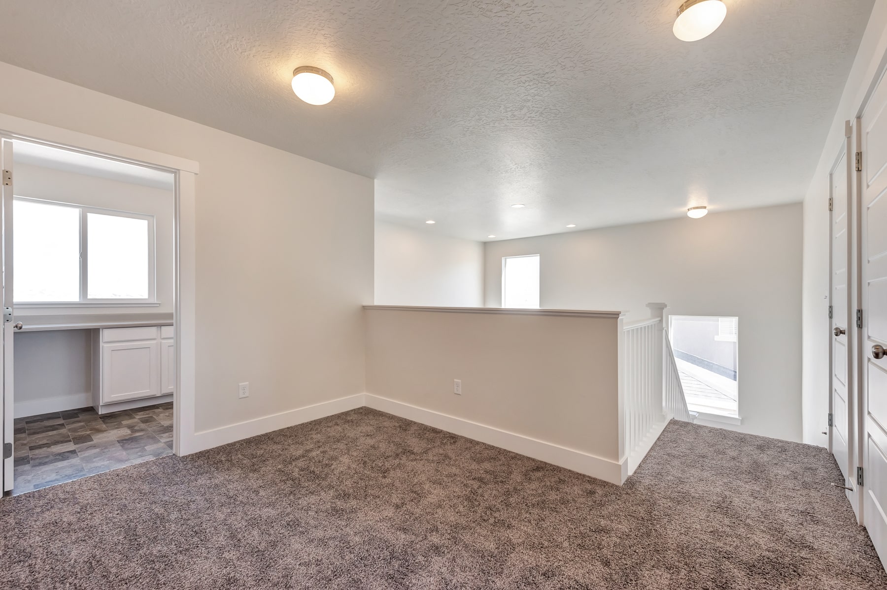Top of the stairs and hallway in a new home from McArthur Homes.