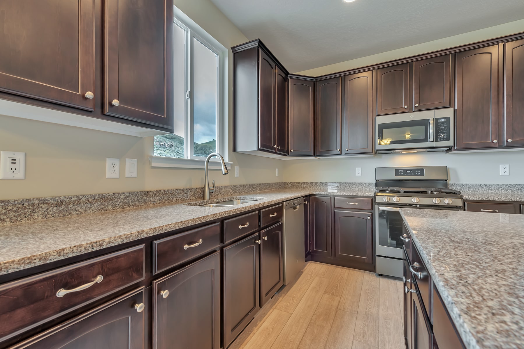 Kitchen with wood cabinets in a new home from McArthur Homes.
