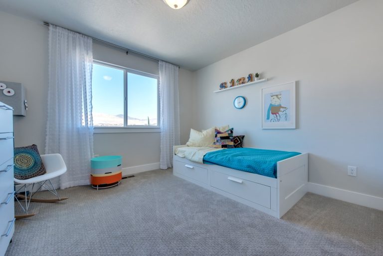 bedroom with blue bedsheets in a mcarthur home