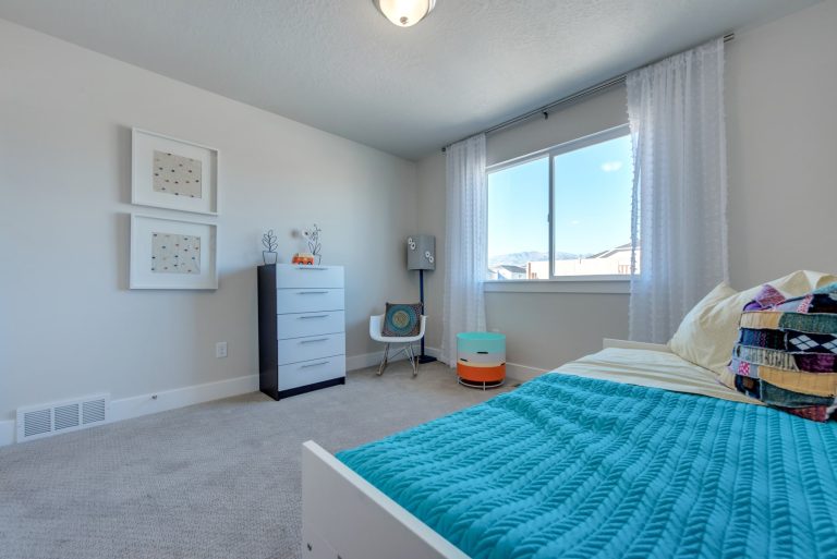 bedroom with blue bedsheets in a mcarthur home