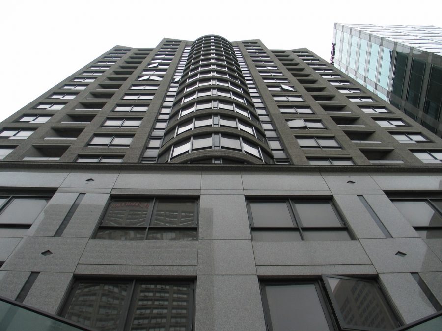 A ground up view of a building full of condos