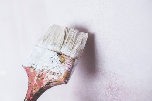 A white paintbrush on a white wall