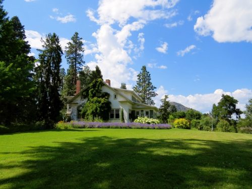 A white house on a green lawn