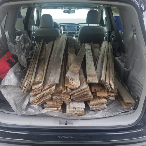 Back of car filled with wood planks