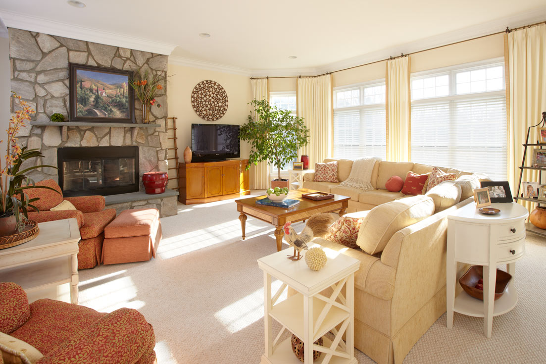 Living room in the 2000s with a TV over the fireplace and large windows