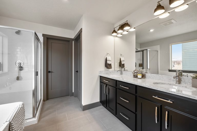 Bathroom with glass door shower and two sinks Inside A New Home From McArthur Homes