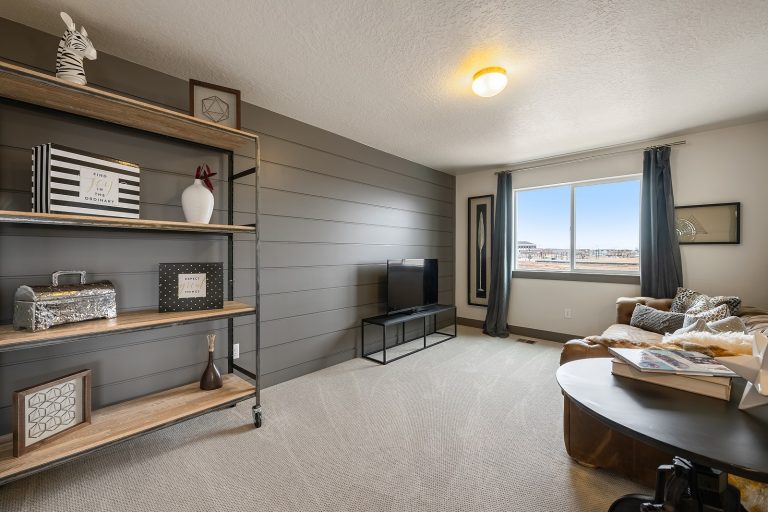 Loft area with a couch Inside A New Home From McArthur Homes