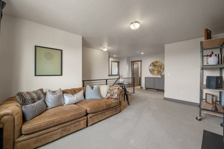 Loft area with a couch Inside A New Home From McArthur Homes