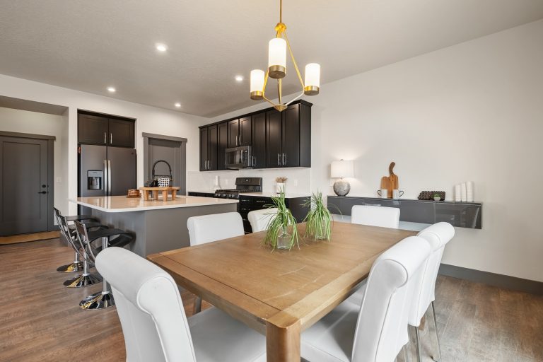 Open Concept Dining Room and Kitchen With An Island Inside a New Home From McArthur Homes