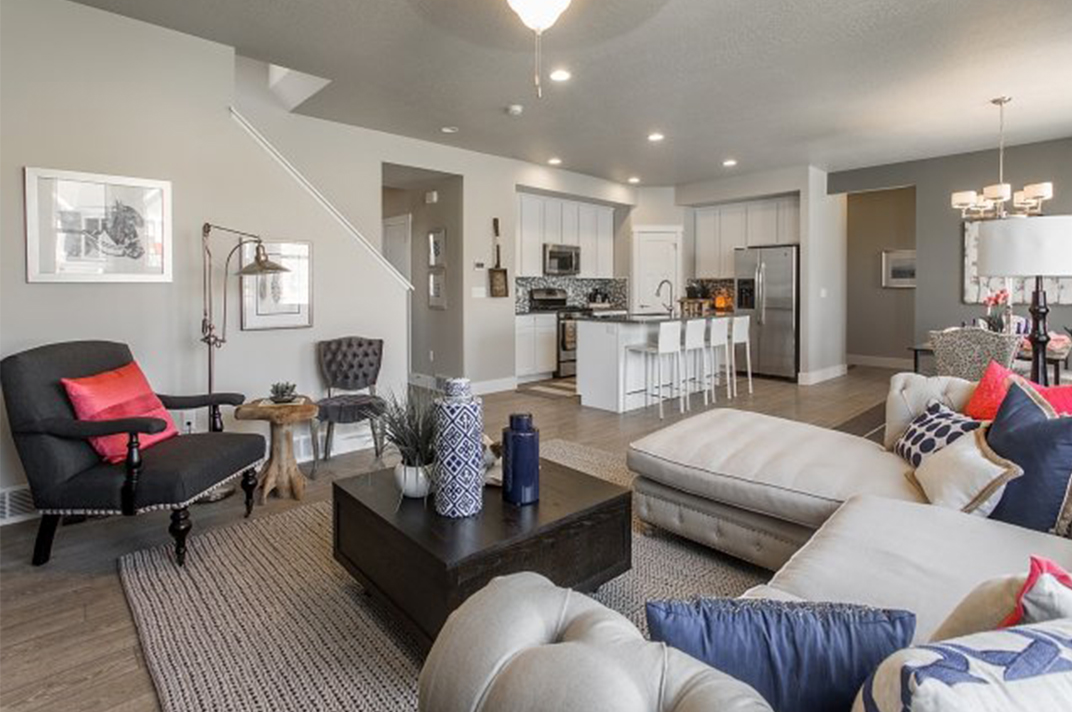 living room with kitchen and dining room behind it Inside A New Home From McArthur Homes