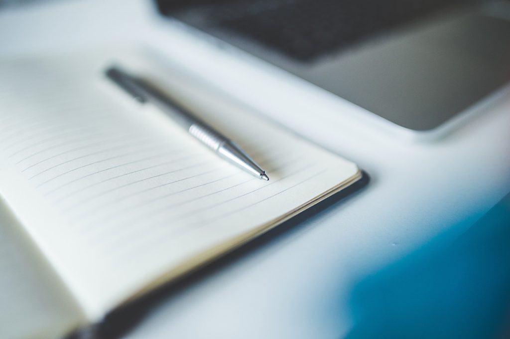 Pen on a open notebook for terms to know when buying a new home.