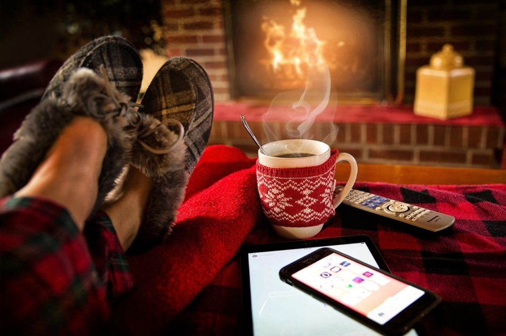 Cozying up with hot chocolate by the fireplace in a new home from McArthur Homes.