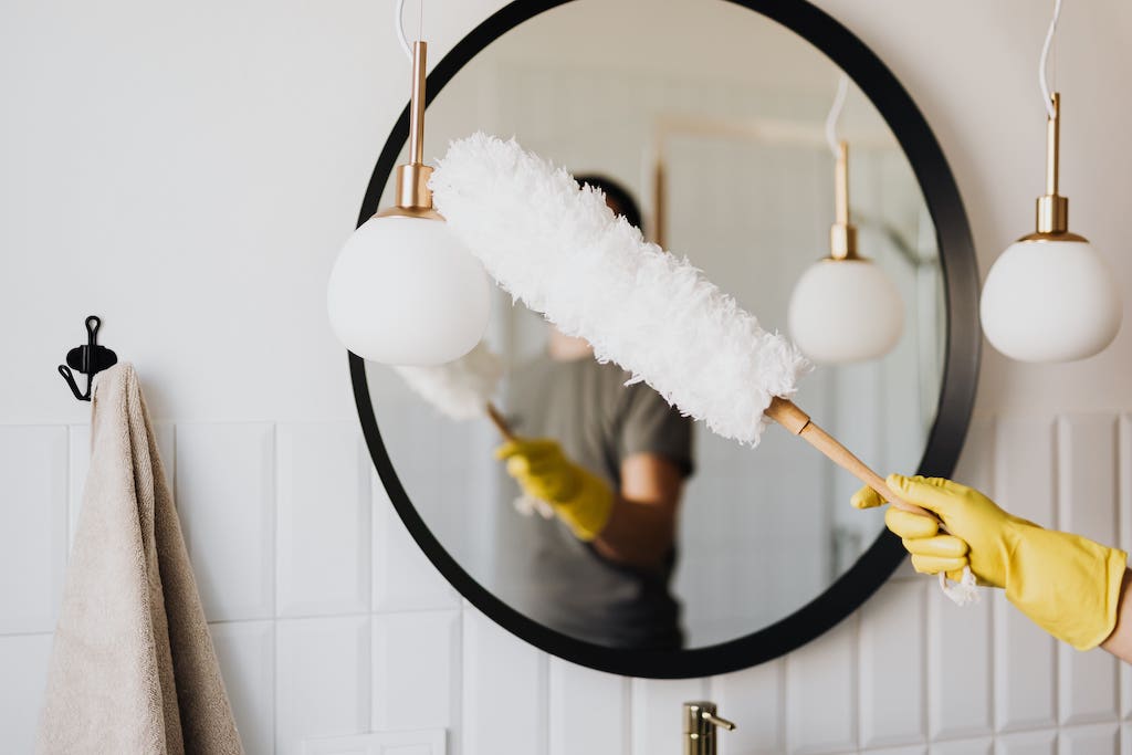 Dusting Mirror With Duster in New Home