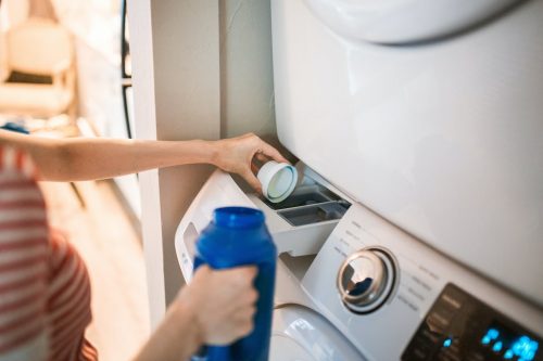 Pouring Laundry Detergent Into Washing Machine