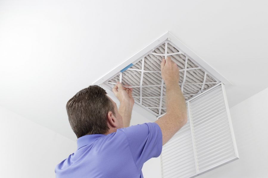 Man Replacing Air Filter in New Home