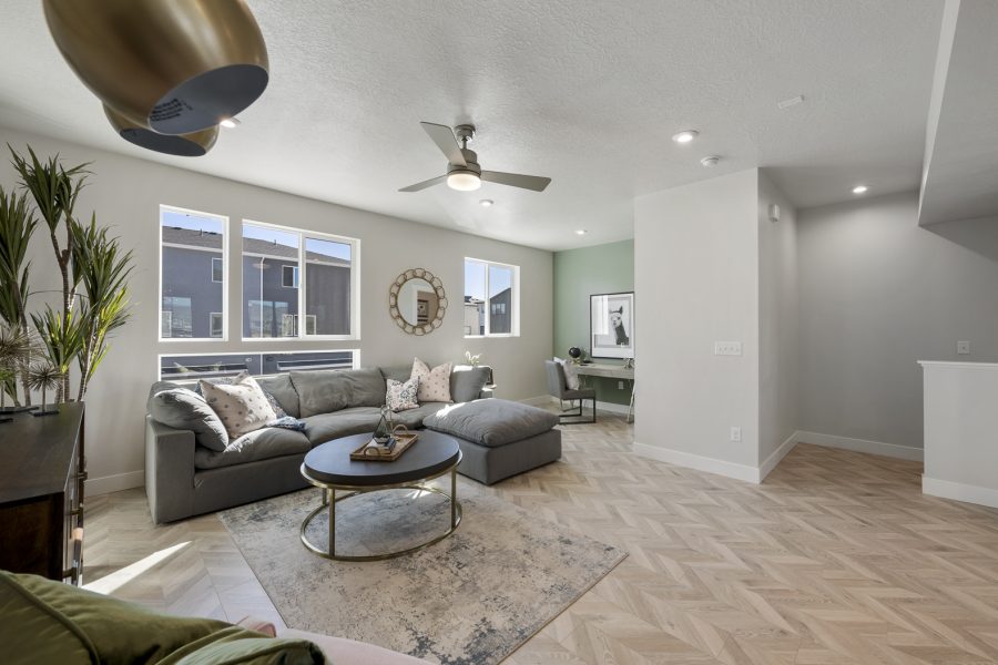 Gathering area in a new home with a L shaped couch.