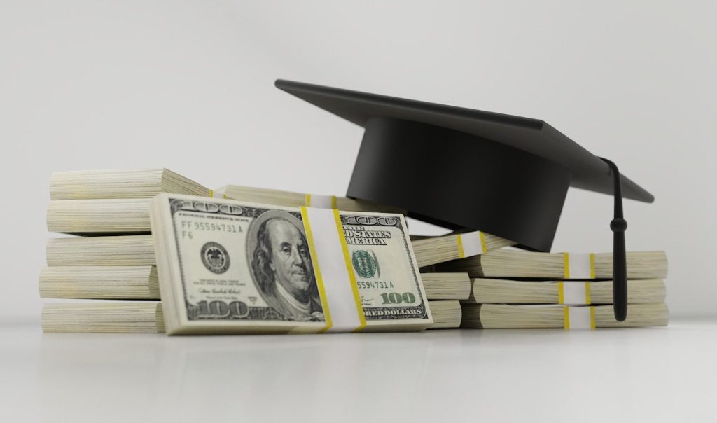 Stacks of Money Under A Student Cap