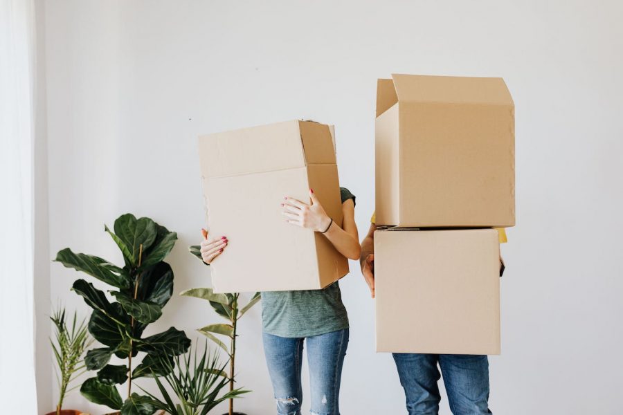 Making A Move Eco Friendly Image Of Two People Carrying Boxes