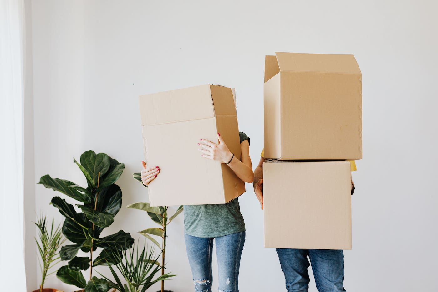 Making A Move Eco Friendly Image Of Two People Carrying Boxes