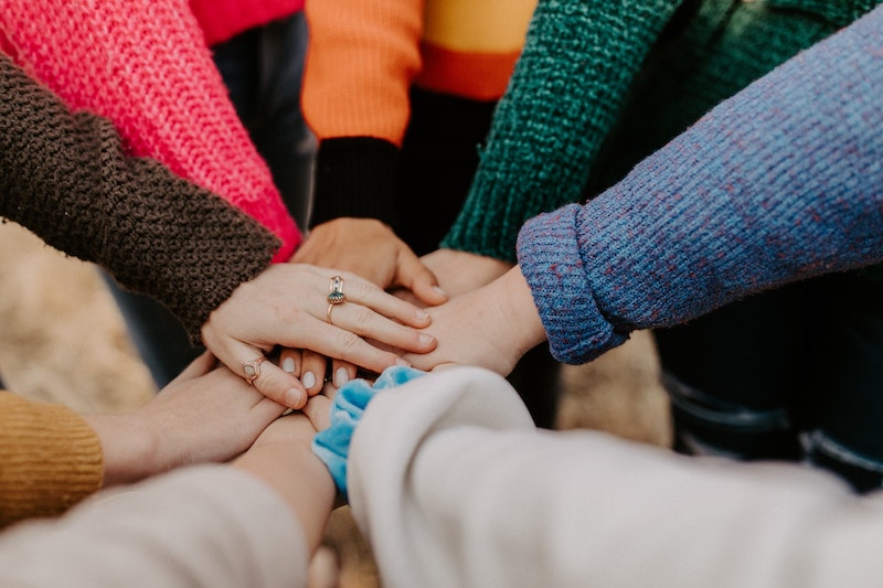 Peoples Hands Piled Together Helping