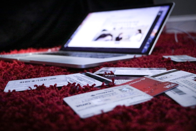 Laptop With Credit Cards In Front Being Consolidated for Home Buying