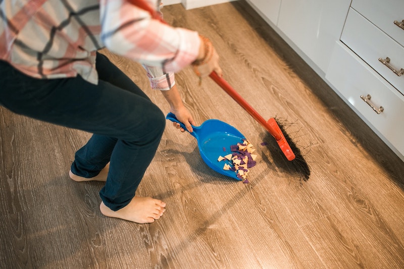 Person Sweeping Laminate Floor