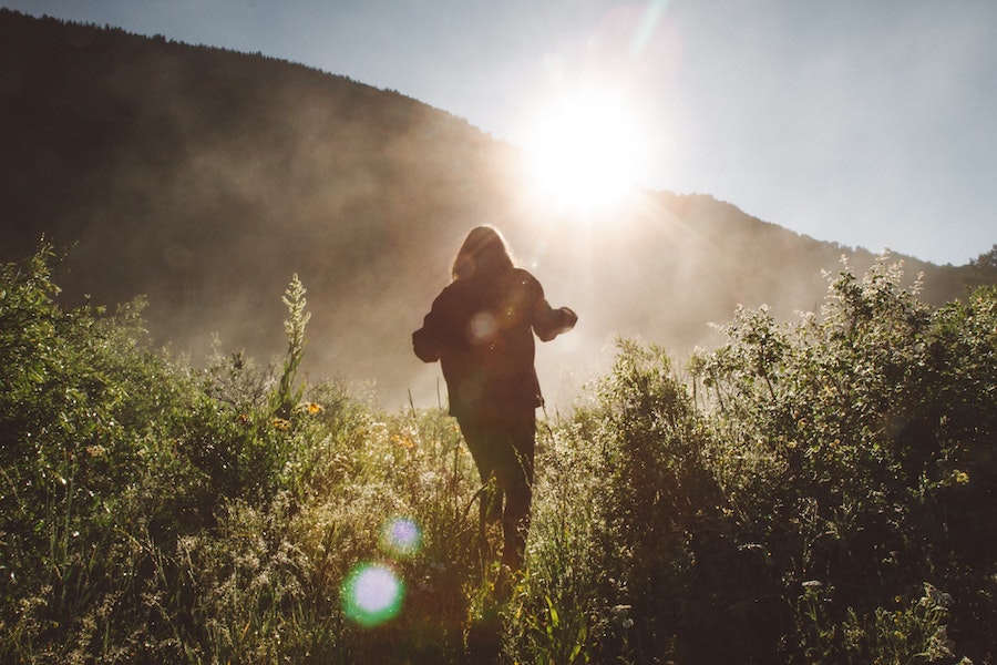 Person Hiking on a Path With The Sun Shining
