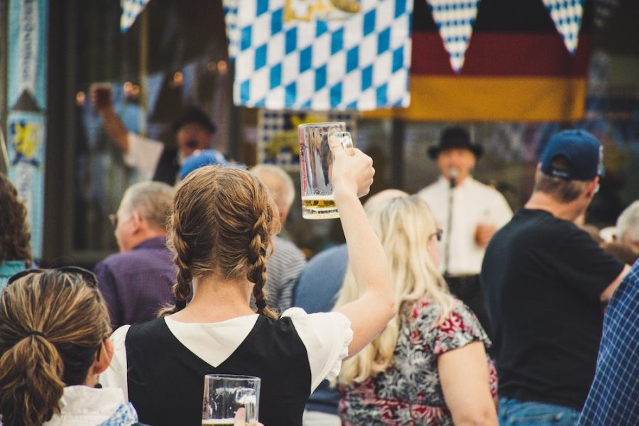 Woman Standing in a Crowd Holding Up Beer Glass at Oktoberfest