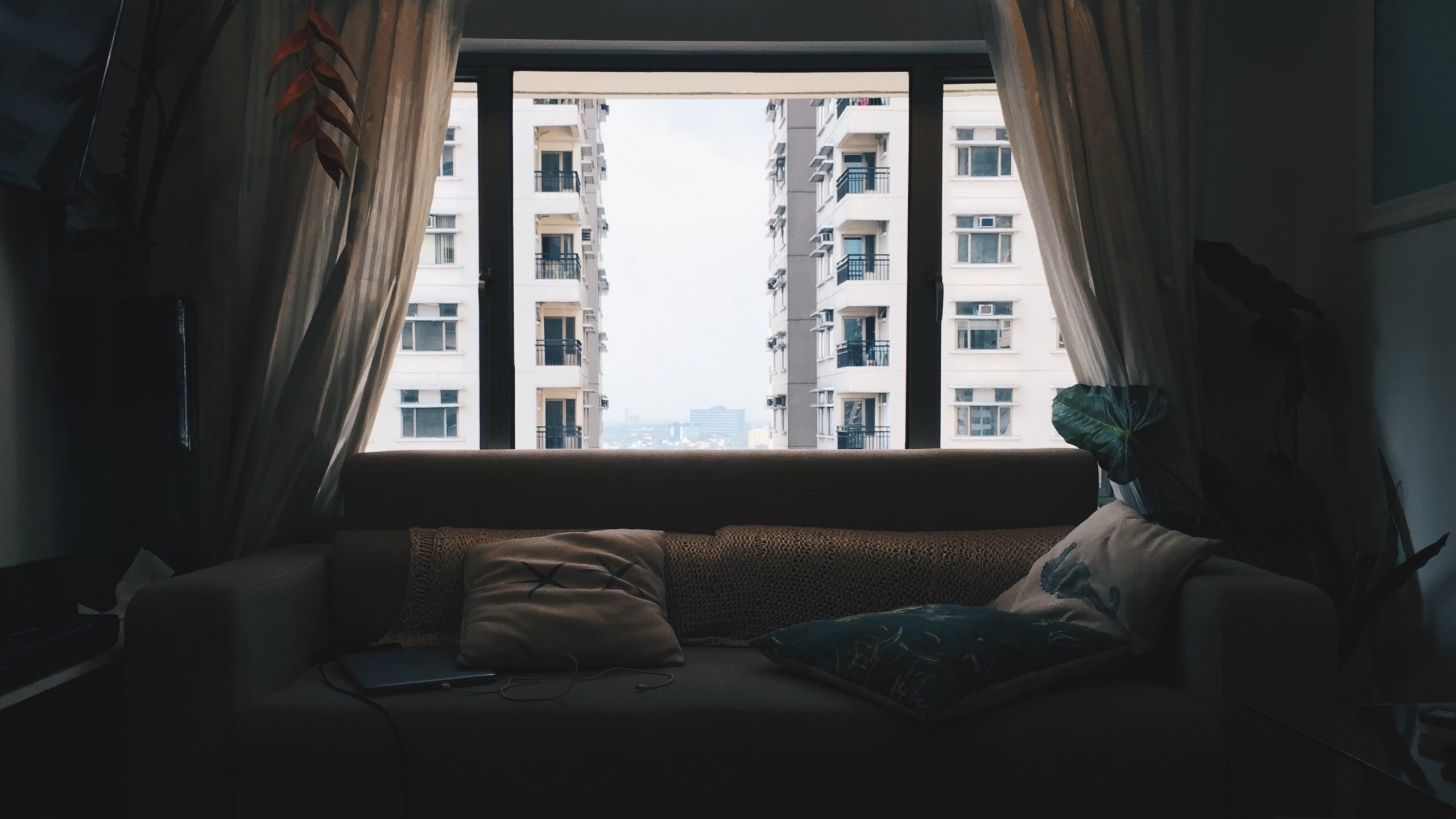 A large Window With a Couch in front of it