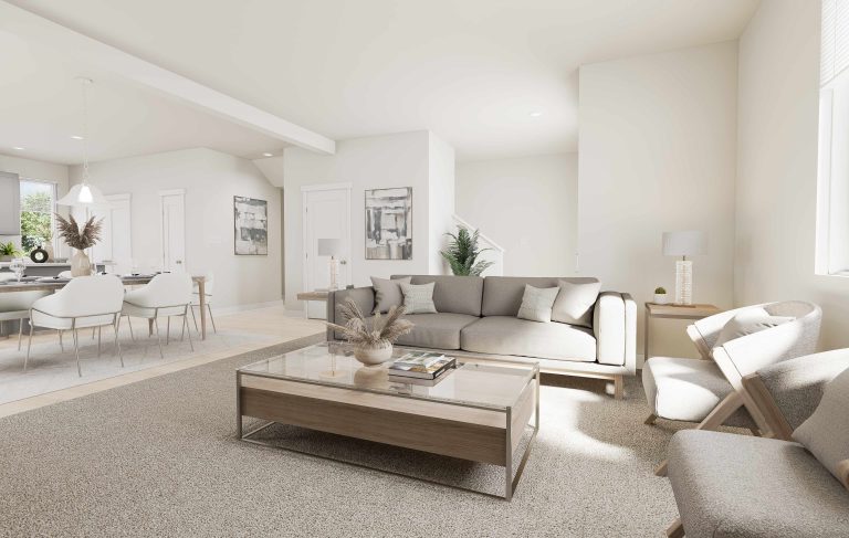 A bright, modern living room with neutral tones features a gray sofa, two armchairs, and a glass coffee table with decor—reflecting the airy style found in many homes in Utah. Sunlight streams through large windows, creating a welcoming atmosphere.