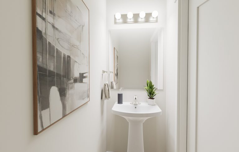 A small, modern bathroom featured in homes in Utah, with white walls, a pedestal sink, a rectangular mirror, four-bulb vanity lighting, a potted plant, hand towels, and abstract artwork on the left wall.