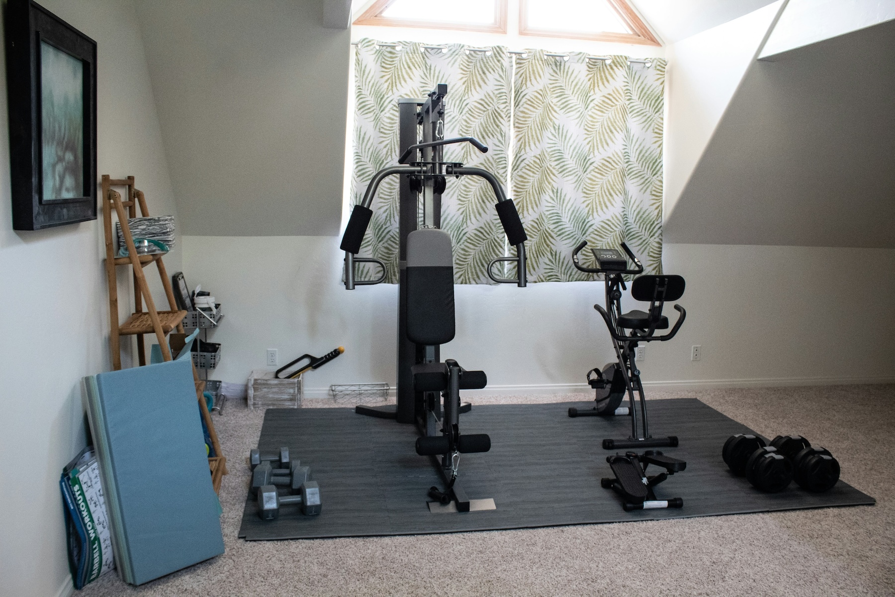 Home gym with multiple workout machines in a new home