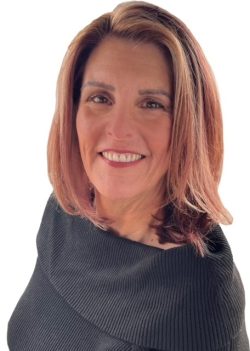 Smiling woman with shoulder-length, light brown hair wearing a black, off-the-shoulder top, pictured against a plain white background—perfect for profiles of agents specializing in homes in Utah.