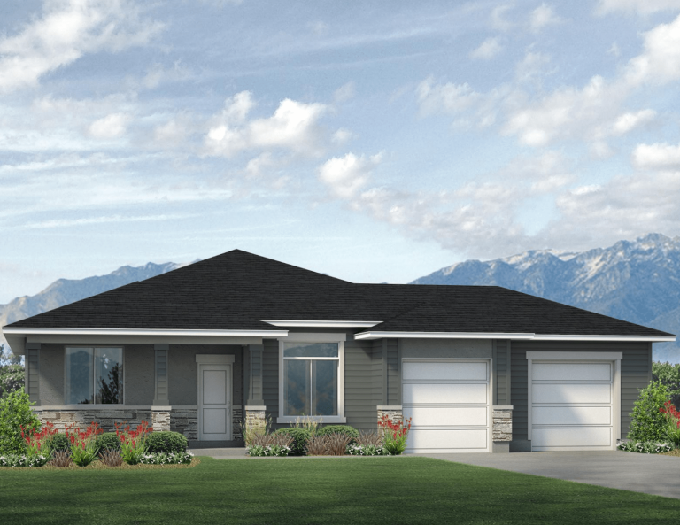 Single-story modern house with a dark roof, gray siding, stone accents, large windows, and a double garage. There are green lawns, shrubs, and mountains in the background beneath a partly cloudy sky.