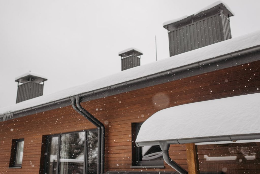Gutters in winter with snow and icicles in them.