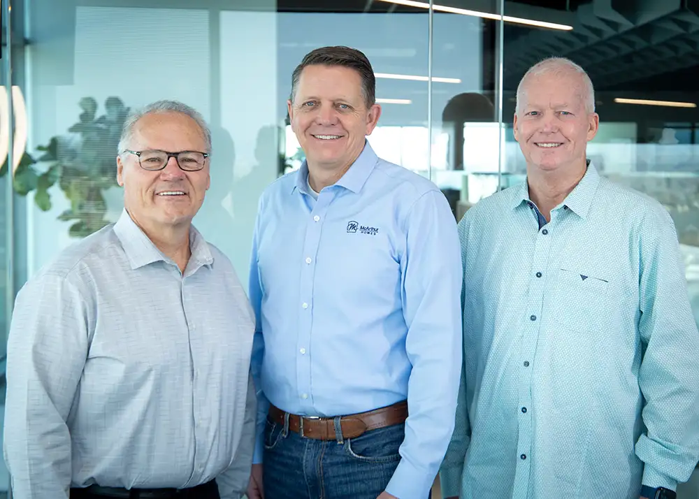 McArthur Homes owners Richard Staples, John Gassman, and Shane Cook standing together at the company office