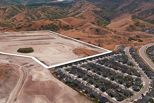 Aerial view of the Panorama development site outlined in white, bordered by homes and foothills